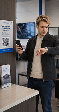 Customer scanning an on-site QR code at an automotive service center